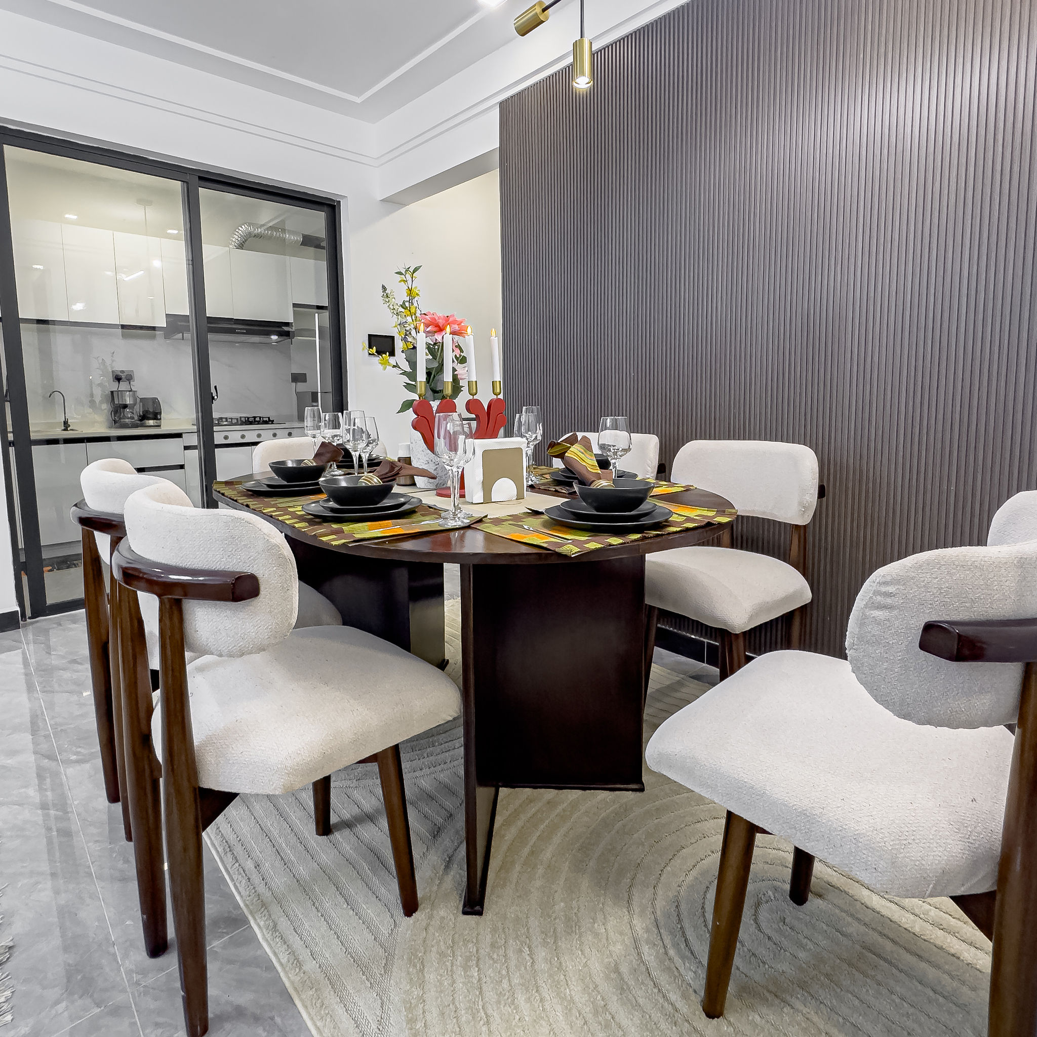 Dining area with set table, flowers, and candles